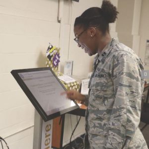 A woman using the new kiosk at JBER