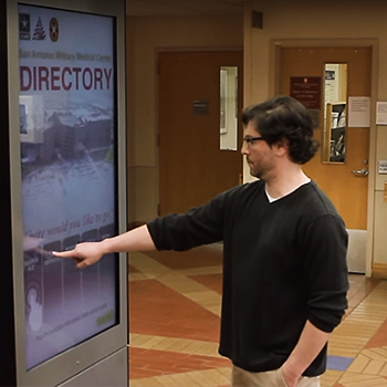 A man uses the wayfinding kiosk at BAMC